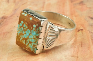 Genuine Number 8 Turquoise set in Sterling Silver Ring. The Number 8 mine is located in Eureka County Nevada. Since 1976 there has been no Number 8 Turquoise mined. There is however, an existing stock pile that Mr. Dowell Ward, the last owner of the Number 8 mine, had stocked away for later sorting. The Turquoise is a collector's item--because once the reserve is gone there will be no more material released onto the market. The Gold Mining Company owns the claim to the Number 8 mine and it has been swallowed up by the gold mining operations. This is some of the last Number 8 Turquoise to be had and will be a great addition to your collection. Created by Navajo Artist Will Vandever. Signed.